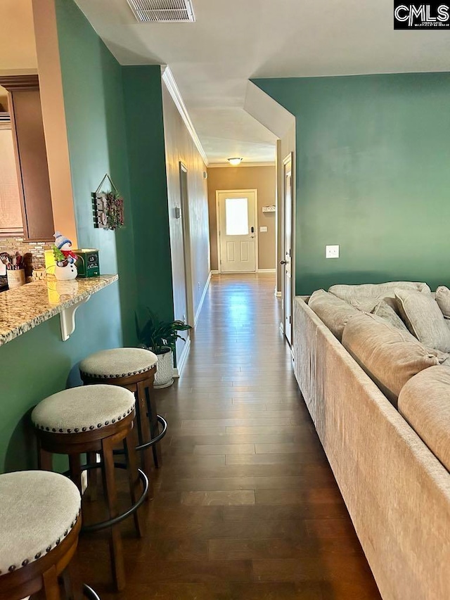 corridor with crown molding and dark hardwood / wood-style flooring