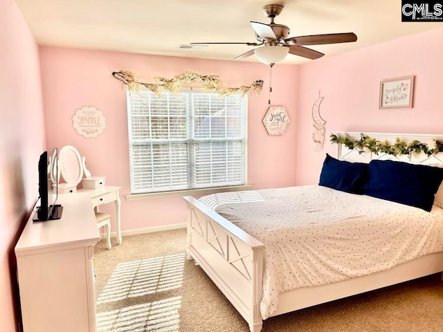 bedroom with ceiling fan and light carpet