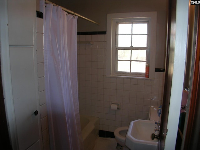 full bathroom with shower / tub combo, toilet, tile walls, and sink