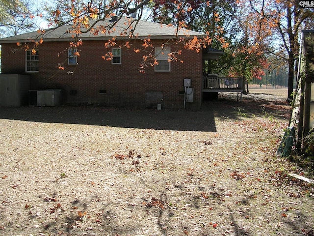 view of home's exterior with a wooden deck