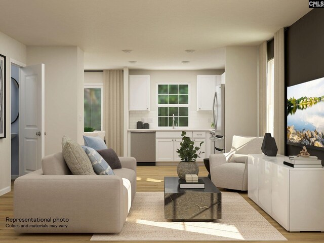 living room featuring sink and light hardwood / wood-style flooring