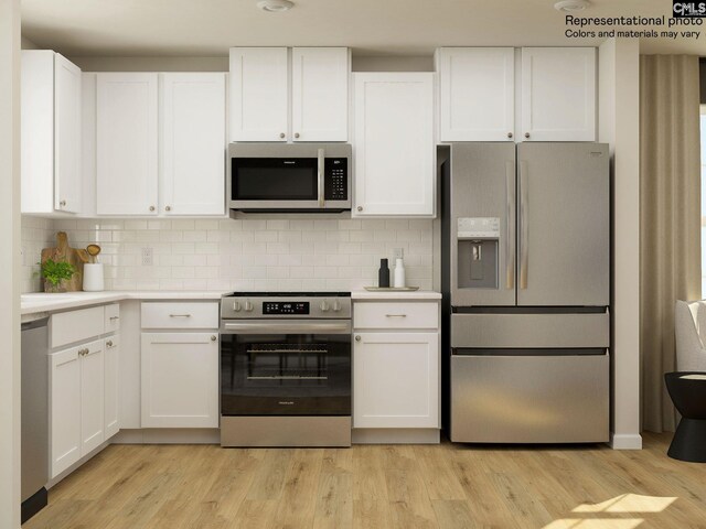 kitchen featuring backsplash, light wood-type flooring, white cabinetry, and stainless steel appliances