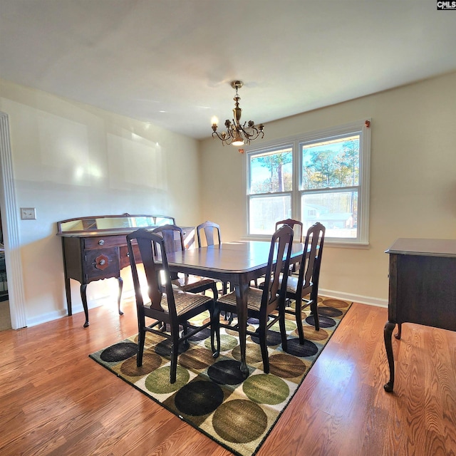 dining room with a chandelier and light wood-type flooring