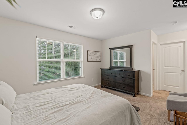 carpeted bedroom featuring multiple windows