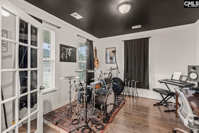 interior space featuring ornamental molding and hardwood / wood-style flooring