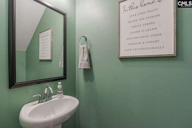 bathroom with vaulted ceiling and sink