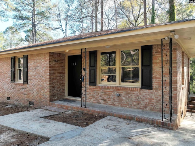 view of exterior entry featuring a patio area