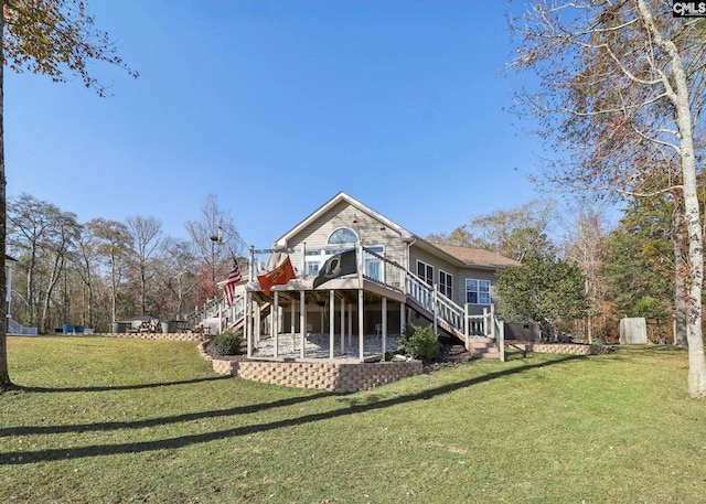 rear view of property with a lawn, a deck, and a patio