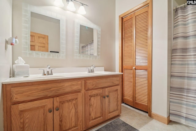 bathroom with tile patterned floors and vanity