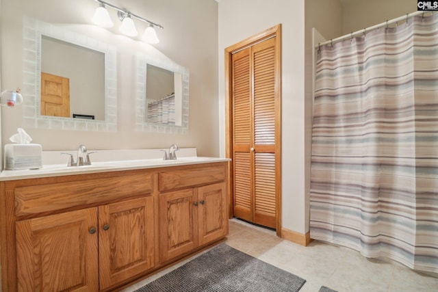 bathroom featuring tile patterned flooring and vanity