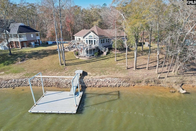 view of dock featuring a yard and a water view