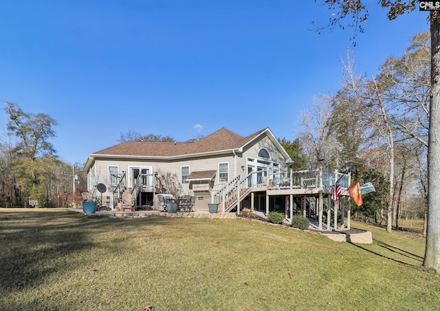 back of property featuring a yard and a wooden deck