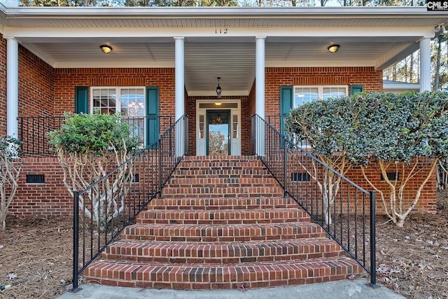 view of exterior entry featuring a porch