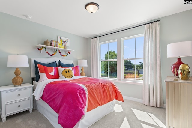 bedroom featuring carpet and baseboards