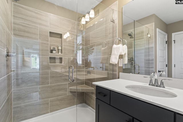 bathroom featuring a stall shower and vanity