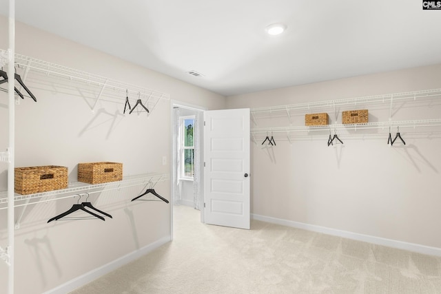 spacious closet with light carpet and visible vents