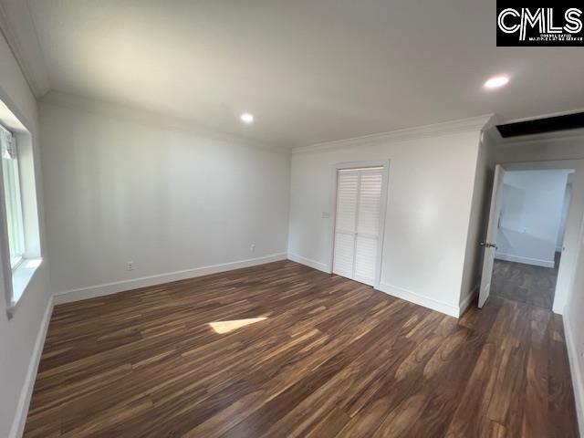 interior space with dark hardwood / wood-style flooring and crown molding