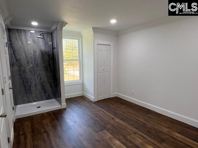 empty room with dark hardwood / wood-style floors and ornamental molding