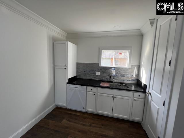 kitchen with backsplash, white cabinetry, dishwasher, and sink