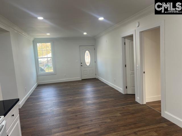 foyer entrance with dark hardwood / wood-style flooring and crown molding