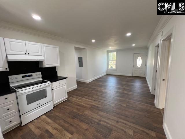 kitchen with white electric range oven, white cabinets, crown molding, and dark wood-type flooring