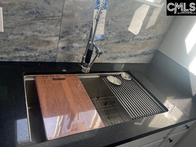 interior space with sink and white cabinets