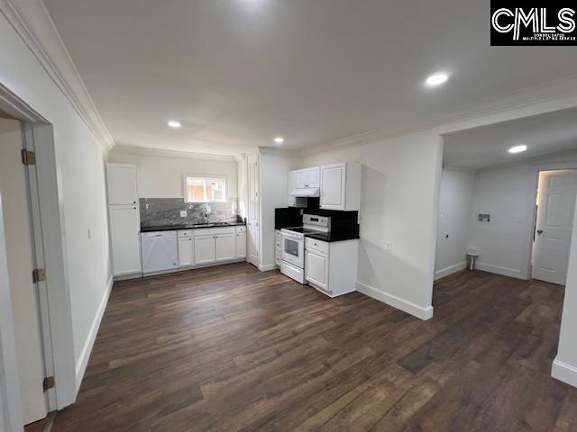 kitchen with decorative backsplash, dark hardwood / wood-style flooring, crown molding, white cabinets, and white electric range