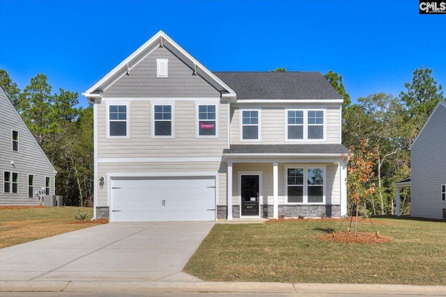 view of front of property with covered porch, cooling unit, a garage, and a front yard