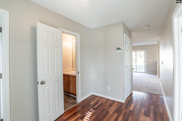 hall featuring dark hardwood / wood-style flooring and a textured ceiling