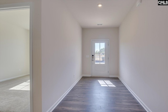 doorway to outside featuring dark wood-type flooring