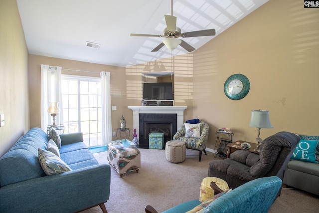 carpeted living room with ceiling fan and high vaulted ceiling