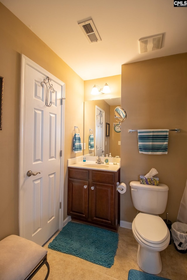 bathroom with tile patterned flooring, vanity, and toilet