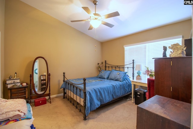 carpeted bedroom featuring vaulted ceiling and ceiling fan