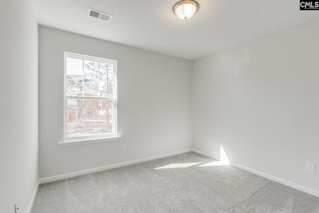 carpeted empty room with visible vents and baseboards