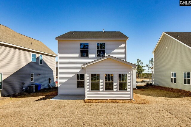 rear view of property featuring central AC