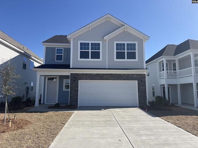 view of front facade featuring a garage, concrete driveway, and board and batten siding