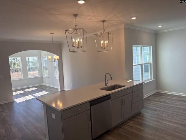 kitchen with dishwasher, ornamental molding, an island with sink, and a sink