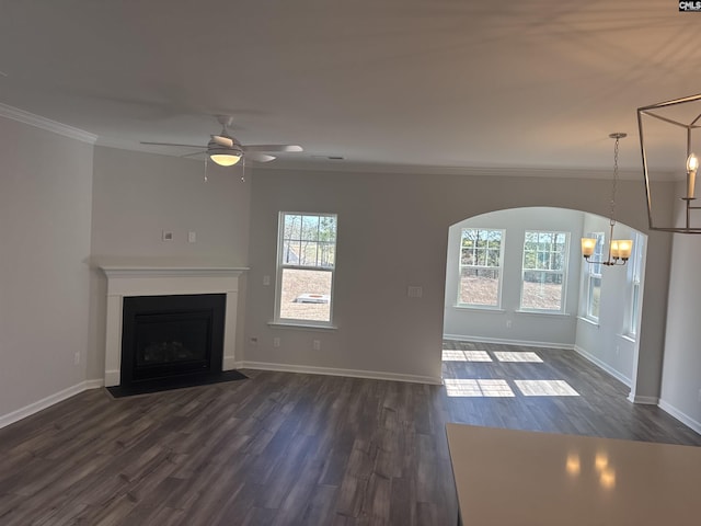 unfurnished living room featuring baseboards, a fireplace with flush hearth, ornamental molding, and dark wood-style flooring