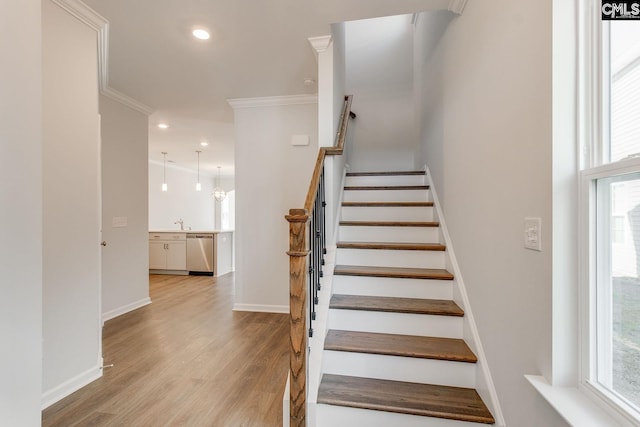 staircase with recessed lighting, baseboards, crown molding, and wood finished floors