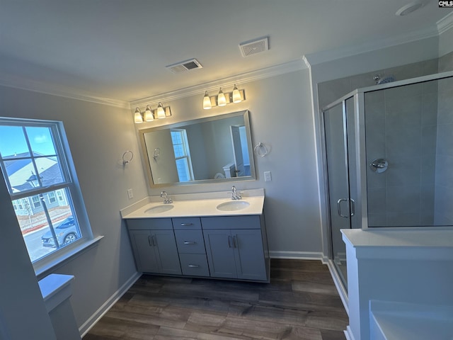 bathroom featuring crown molding, visible vents, and a sink