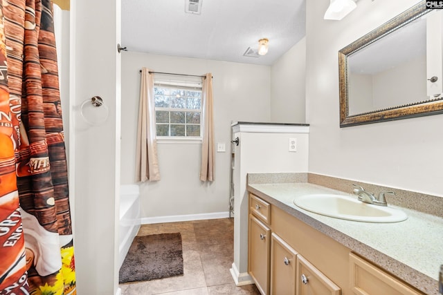 bathroom featuring tile patterned floors, vanity, and a textured ceiling