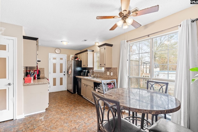 kitchen with backsplash, ceiling fan, a textured ceiling, and black dishwasher