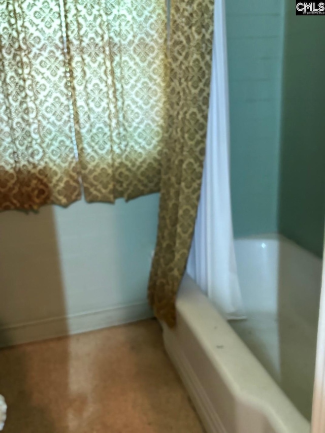 bathroom with shower / bath combo with shower curtain