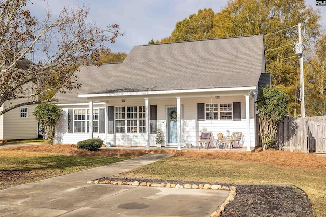 view of front of property with a porch and a front yard