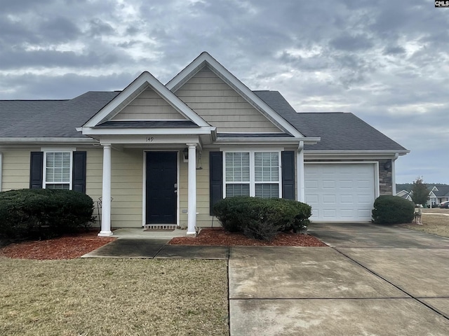 view of front of home with a garage and a front lawn