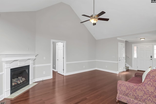 unfurnished living room with dark hardwood / wood-style flooring, high vaulted ceiling, and ceiling fan