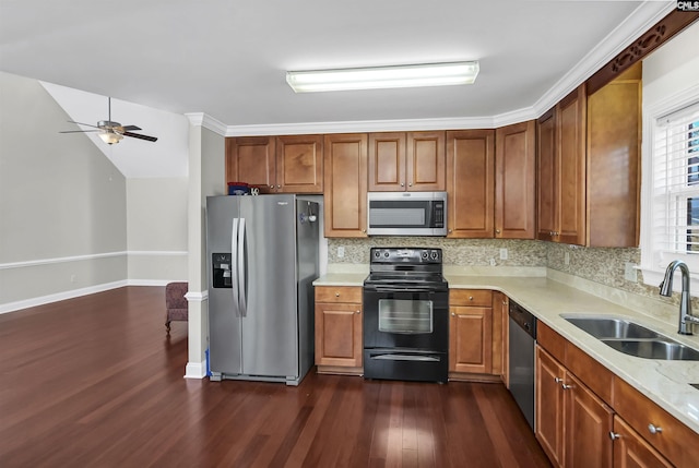 kitchen featuring dark hardwood / wood-style flooring, backsplash, ornamental molding, stainless steel appliances, and sink