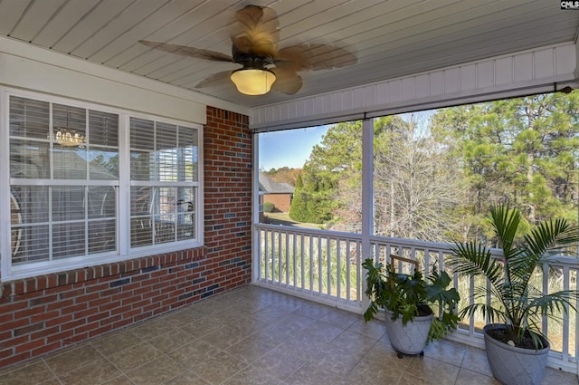 sunroom / solarium featuring ceiling fan and wood ceiling