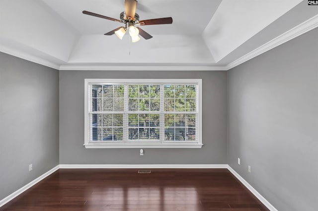 unfurnished room featuring a tray ceiling, ceiling fan, wood-type flooring, and ornamental molding