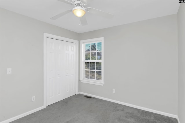 unfurnished bedroom featuring carpet flooring, ceiling fan, and a closet